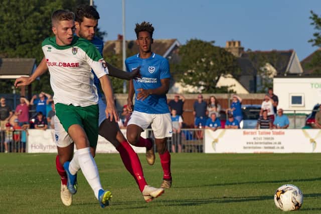 Pompey first-year scholar Haji Mnoga featuring alongside Gareth Evans