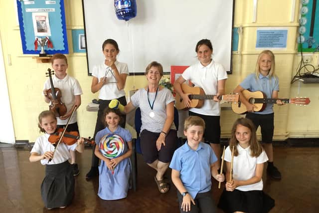 Retiring music teacher Joy Golledge alongside Westover Primary pupils