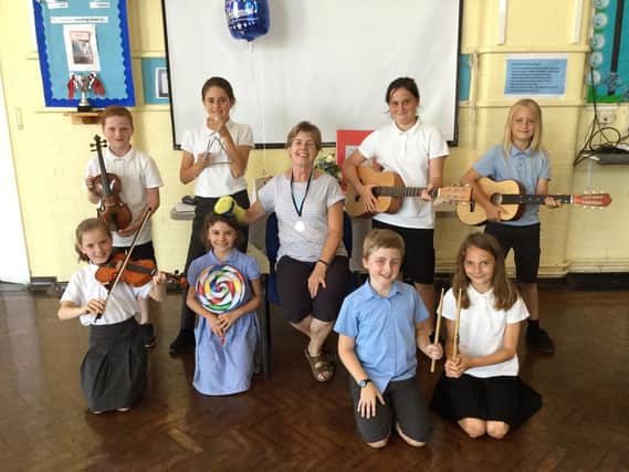 Retiring music teacher Joy Golledge alongside Westover Primary pupils