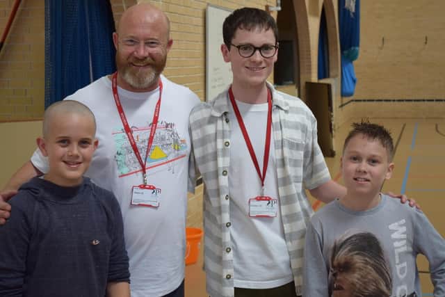 Finlay George, left, and Dylan Hibberd alongside barbers from Head Hairdressing for Men