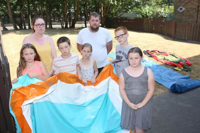Emma Graham and Sean Logan with some of the children who are upset about not having the inflatable Picture: Habibur Rahman
