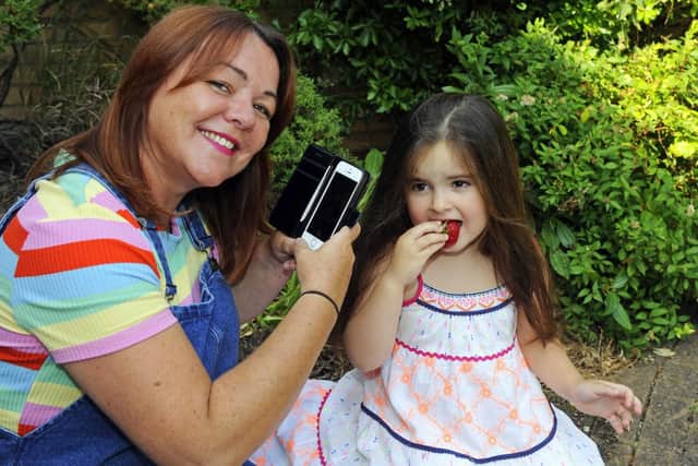 The winner of The News's One Summer's Day 2018 competition is Kate Toman, who photographed her goddaughter Tilly eating a strawberry. Picture by:  Malcolm Wells (180727-8883)