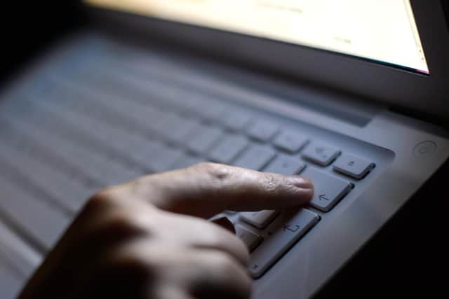 File photo of a person using a laptop. Picture: Dominic Lipinski/PA Wire