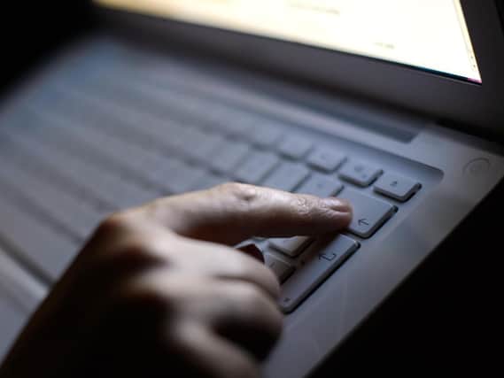 File photo of a person using a laptop. Picture: Dominic Lipinski/PA Wire