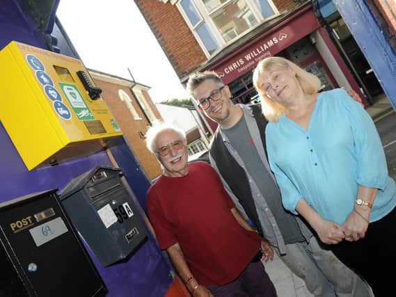 Residents have paid for a new defibrillator which has been installed on the wall of a shop in Castle Road, Southsea. (left to right), Paul Lombardi, shop owner Clive Padfield and Paul's wife, Marilyn.