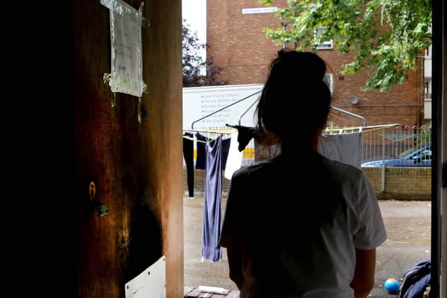 Linda Byrne standing near her flat door with fire damage clearly visible. Picture: Habibur Rahman