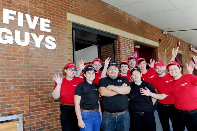Five Guys has opened in Gunwharf Quays, Portsmouth. Pictured is: (back l-r) Jasmin Samuel, Jordan Perchard, George Roxburgh, James Forster, Blade Johnson, William Norn and Elliott Dexter-Sumbler with (front l-r) Abby Hartley, manager Ryan Burrans and Abby Potter.