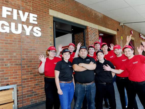 Five Guys has opened in Gunwharf Quays, Portsmouth. Pictured is: (back l-r) Jasmin Samuel, Jordan Perchard, George Roxburgh, James Forster, Blade Johnson, William Norn and Elliott Dexter-Sumbler with (front l-r) Abby Hartley, manager Ryan Burrans and Abby Potter.