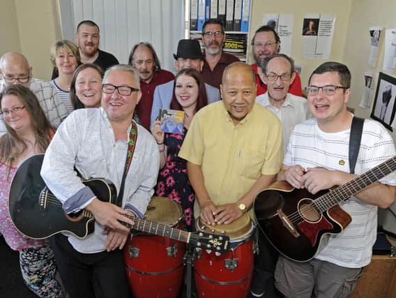 Musical Director Terry Mills (front left) leads the celebrations with staff and clients at Med3 Music in Portsmouth after the charity secured an eleven thousand pounds grant from The Health Lottery