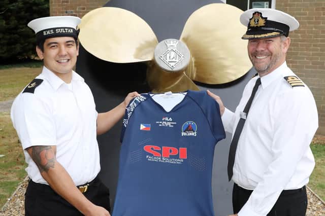 LET (ME) Liam Williams, left, and Commander Jules Philoa from HMS Sultan with Liam's signed shirt from his first international test match. Picture: PO Phot Nicola Harper