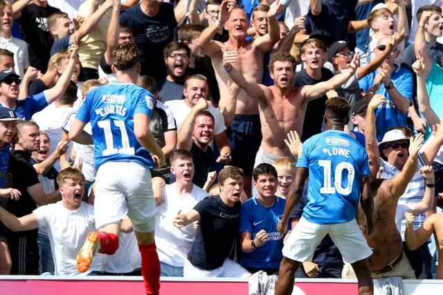 Pompey players and fans celebrate. Picture: Andrew Fosker