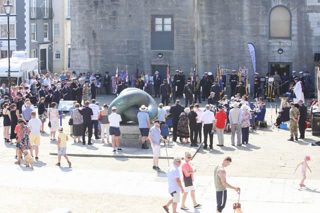 Veterans marching through Old Portsmouth by the Falklands Memorial Stone