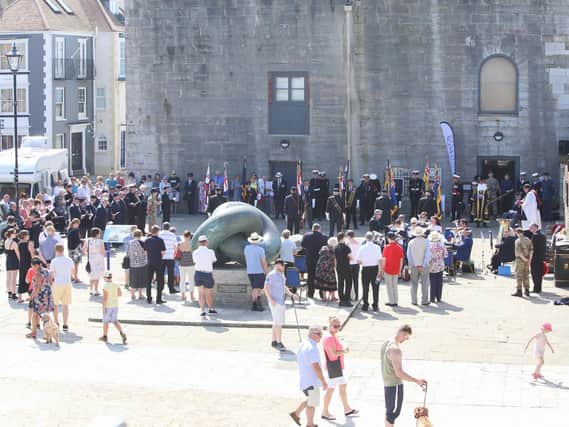 Veterans marching through Old Portsmouth by the Falklands Memorial Stone