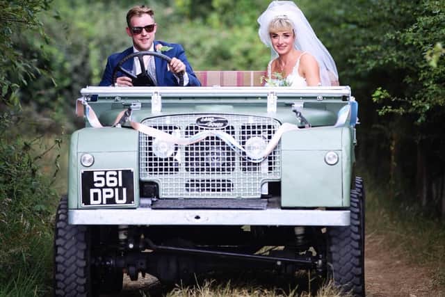 The newlyweds Alice and Sam Coulton in their wedding car, the Series 1 Land Rover.