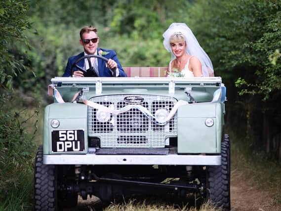 The newlyweds Alice and Sam Coulton in their wedding car, the Series 1 Land Rover.