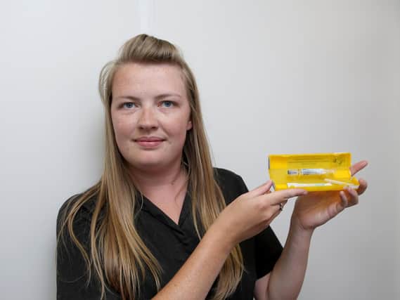 Sophie-Marie Furmedge with the antidote drug at Laly's Pharmacy in Guildhall Walk, Portsmouth