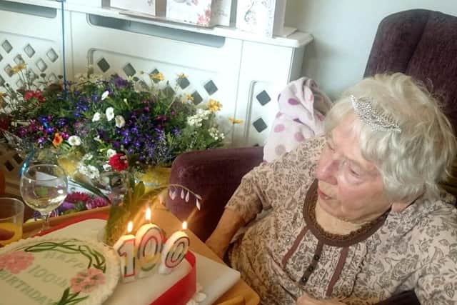 Birthday girl Doreen Hill blowing out the candles on her cake.