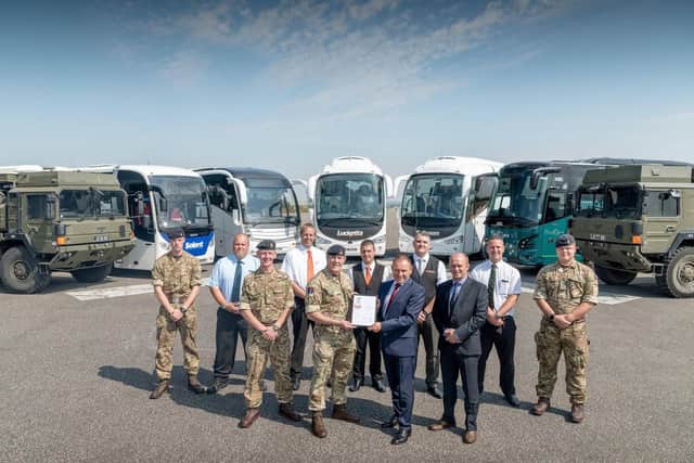 Pictured l to r: (Front row) Dave Nestor - Engineering Workshop Manager, Lieutenant colonel (Lt Col) Ian Coulson - Station Commander, Thorney Island, Tony Lawman  Managing Director and Dave Allen - Operations Director (Back row) drivers of the Lucketts and military vehicles