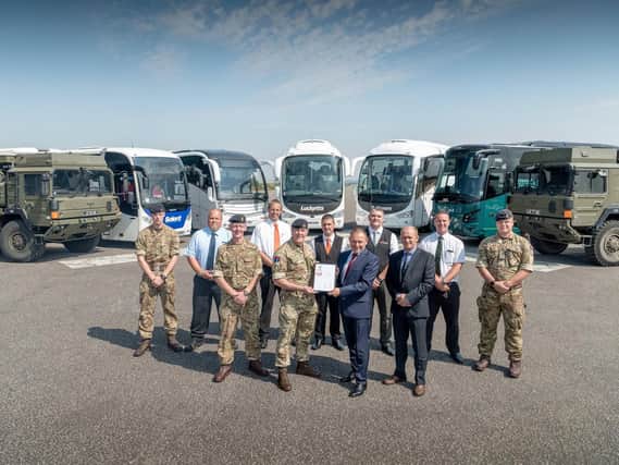 Pictured l to r: (Front row) Dave Nestor - Engineering Workshop Manager, Lieutenant colonel (Lt Col) Ian Coulson - Station Commander, Thorney Island, Tony Lawman  Managing Director and Dave Allen - Operations Director (Back row) drivers of the Lucketts and military vehicles