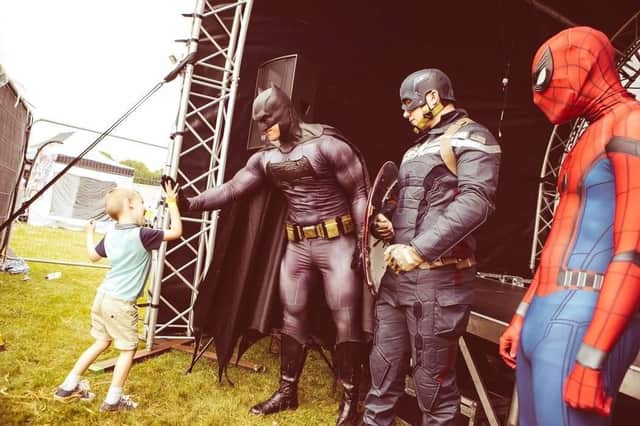 A child meeting his favourite superheroes.