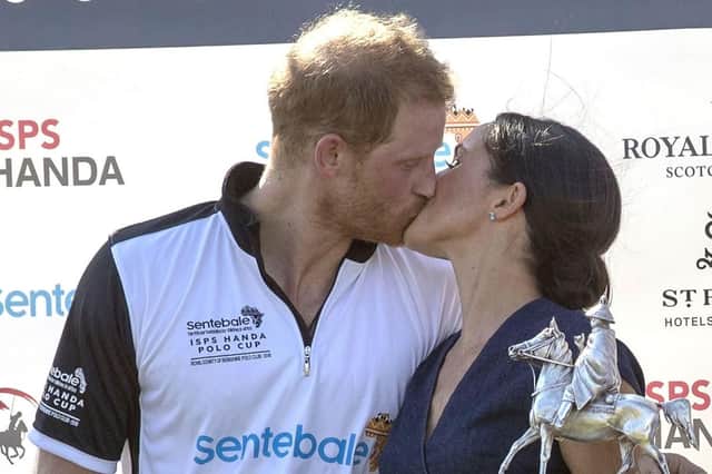 The Duke and Duchess of Sussex kiss at a polo match last month. Picture: PA