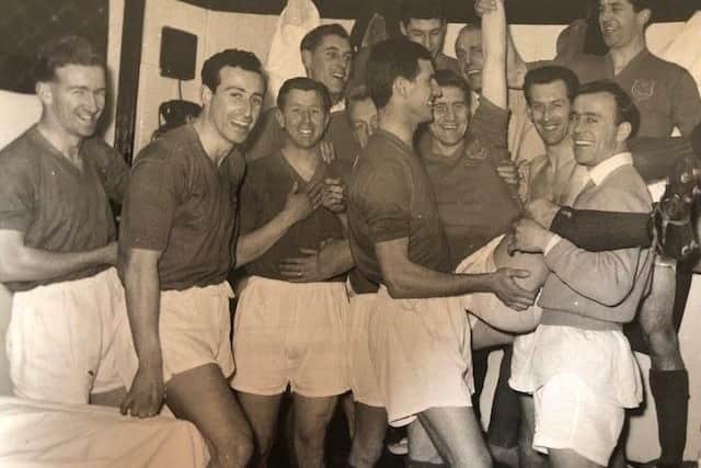 Pompey players, including Ron Saunders, bottom right, celebrate Jimmy Dickinsons 500th appearance in February 1959 following a 4-4 draw at Spurs. Saunders scored a hat-trick in the draw