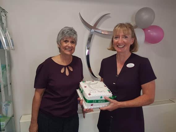 Sharon Nanson, practice manager with Clare Grant, with the cake to commemorate the 25-year anniversary