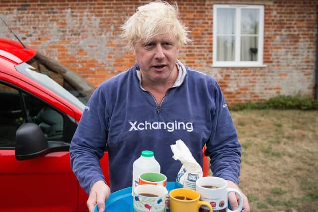 Boris Johnson brings tea for the press to drink outside his house