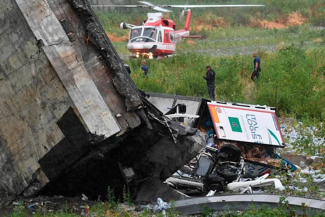 Rescues work among the debris of the collapsed Morandi highway bridge in Genoa. Picture: Luca Zennaro/ANSA via AP