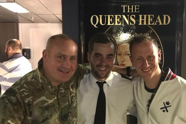 Left to right: WO2 Cozzie Costema, PO Dan Young and CPO(PTI) Sticky Vercoe at the new floating Queen Elizabeth pub  the team on board who will run the Queens Head