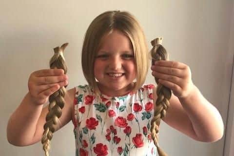 Connie Slydell with the 12in of hair she has had cut off