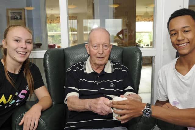 Laura Vahey and Lamin Mbye-Prior alongside resident David Keeping
