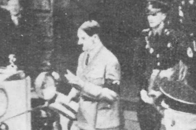 Adolf Hitler leaving a memorial service to King George V.