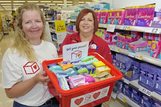 Rebecca Cave, left, who is the Portsmouth North co-ordinator for the Red Box sanitary products project for female students collects donations from Tesco at North Harbour assisted by customer assistant, Julie Knight
Picture: Ian Hargreaves (180815-1_red_box)