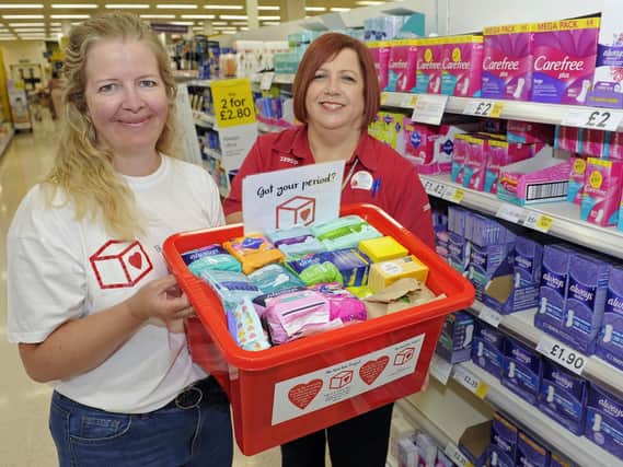 Rebecca Cave, left, who is the Portsmouth North co-ordinator for the Red Box sanitary products project for female students collects donations from Tesco at North Harbour assisted by customer assistant, Julie Knight
Picture: Ian Hargreaves (180815-1_red_box)