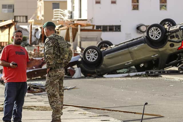 Captain George Eatwell of 40 Commando Royal Marines talking to residents in Road Town, Tortola after Hurricane Irma last year