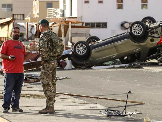 Captain George Eatwell of 40 Commando Royal Marines talking to residents in Road Town, Tortola after Hurricane Irma last year
