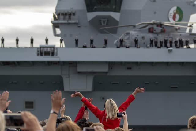 Crowds waved at the aircraft carrier and her crew as they passed.  Photo: Steve Parsons/PA Wire