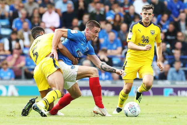 Oli Hawkins is wrestled to the ground by Curtis Nelson during Pompey's victory over Oxford United. Picture: Joe Pepler