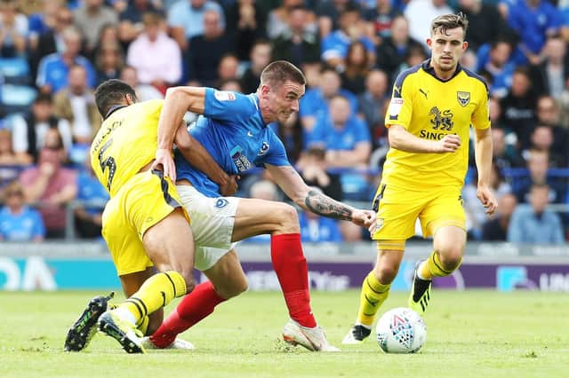 Oli Hawkins is wrestled to the ground by Curtis Nelson during Pompey's victory over Oxford United. Picture: Joe Pepler