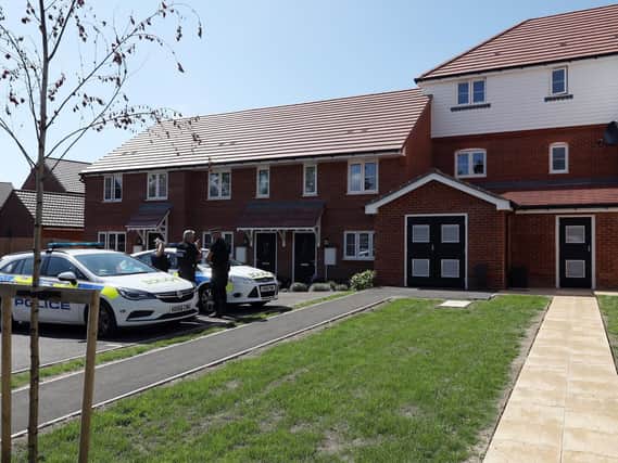 Police at the scene in Fareham where a man's body was found in his flat