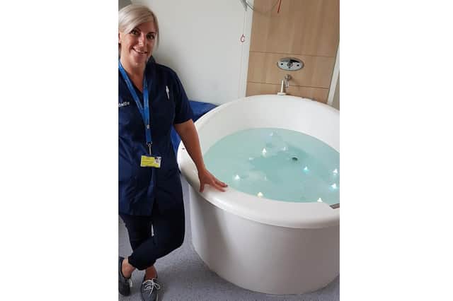 Sarah Finch, a community midwife, next to a birthing pool at St Mary's Hospital, Portsmouth.