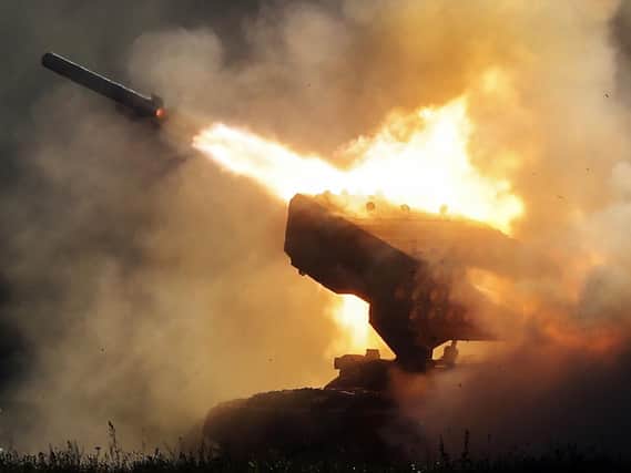 Russian heavy flamethrower system TOS-1 fires during the International Military Technical Forum Army-2018 in Alabino, outside Moscow, Tuesday, Aug. 21, 2018. Russia has displayed its latest weapons at a military show aimed at attracting more foreign customers. (AP Photo/Pavel Golovkin)