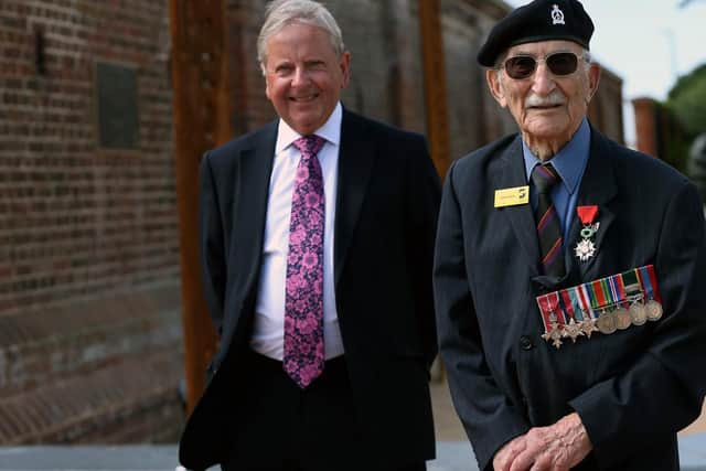 D-Day veteran John Jenkins received a cheque on behalf of D-Day Story from the chairman of the Portsmouth D-Day Museum Trust, Roger Ching. Photo: Chris Moorhouse