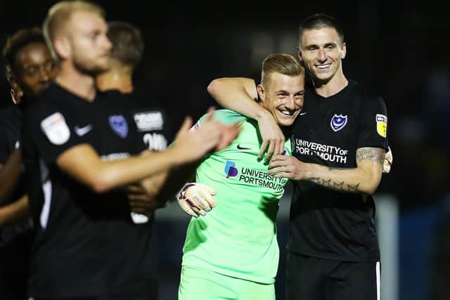Craig MacGillivray and Oli Hawkins celebrate Pompey's victory at Bristol Rovers. Picture: Joe Pepler