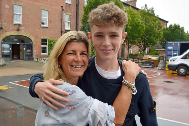 Finn Elliot, star of The Crown TV series, hugs his mother, Mini, after collecting his GCSE results at Portsmouth Grammar School. Picture: Ben Mitchell/PA Wire