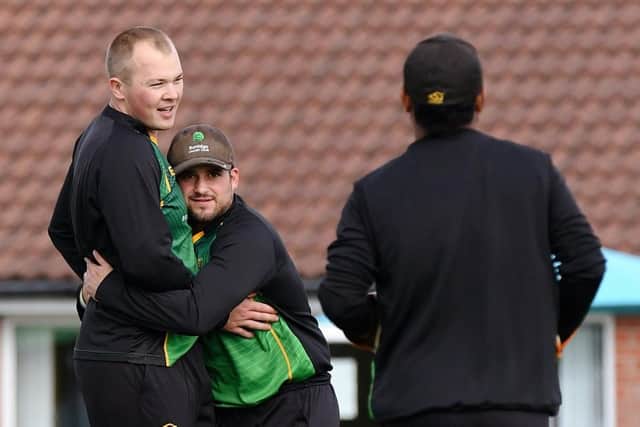 Burridge bowler Sullivan White, left, is congratulated by Hilio de Abreu. Picture: Neil Marshall