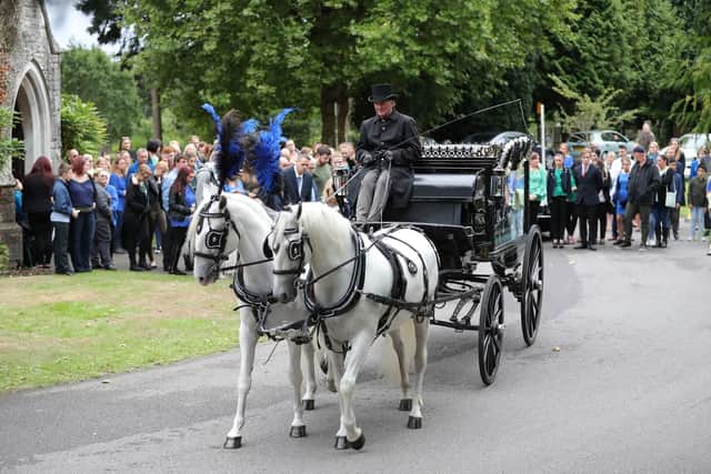 A horse-drawn hearse carrying the coffin of 13-year-old Lucy McHugh after her funeral ceremony at Hollybrook cemetery in Shirley, Southampton.