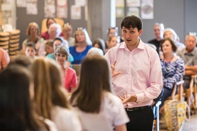 Cathedral staff member Adrian Green leading a singing workshop in St Marys Church, Hayling Island, with pupils from the Hayling College. (Photo credit: Mike Cooter)