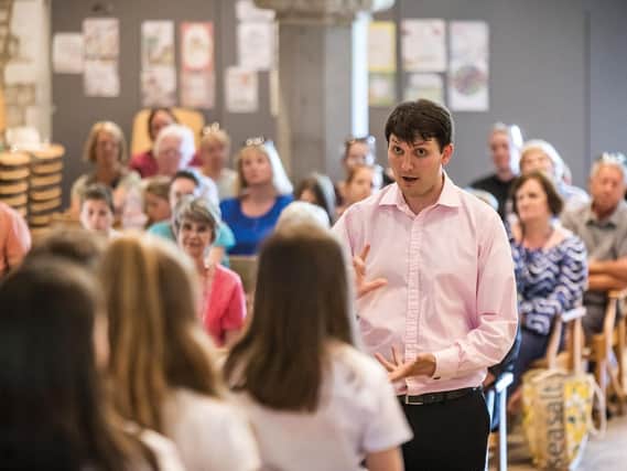 Cathedral staff member Adrian Green leading a singing workshop in St Marys Church, Hayling Island, with pupils from the Hayling College. (Photo credit: Mike Cooter)